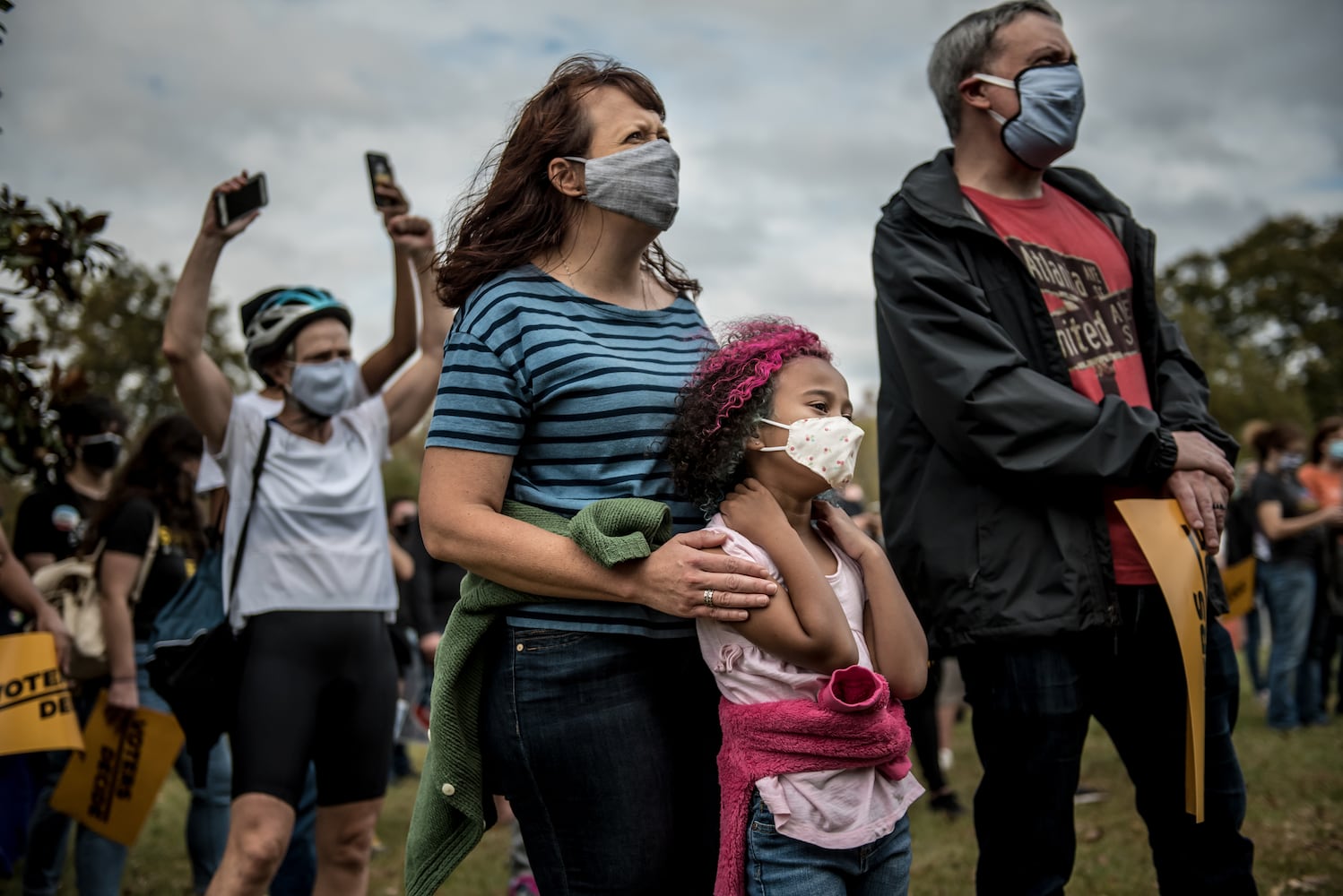 Cassie Keeler, 45, and her daughter, Lucy Johnson, 7, listen to a speaker at a rally at Freedom Park, in Atlanta, after it was announced that Joe Biden was elected the 46th president of the United States, on Saturday, Nov. 7, 2020. President-elect Biden achieved victory offering a message of healing and unity. He will return to Washington facing a daunting set of crises. (Meridith Kohut/The New York Times)