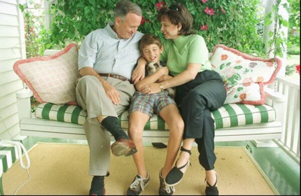 John and Patsy Ramsey sit on a porch swing with their 10-year-old son Burke in 1997. The Rocky Mountain News had just published a story quoting Ramsey friends and family members contending the little girl's parents could not be responsible for her death.