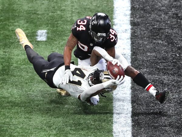 Saints running back Alvin Kamara dives into the end zone past Falcons cornerback Darqueze Dennard for a touchdown during the third quarter Sunday, Dec. 6, 2020, at Mercedes-Benz Stadium in Atlanta. (Curtis Compton / Curtis.Compton@ajc.com)