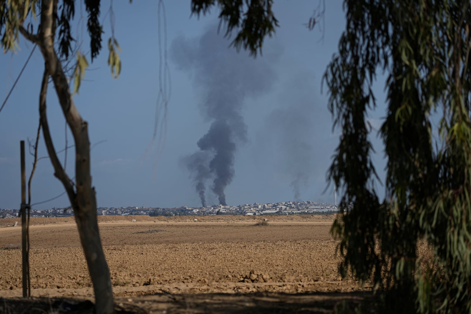 Smoke from Israeli bombardment rises from the Gaza Strip, as seen from southern Israel, Wednesday, Oct. 16, 2024. (AP Photo/Tsafrir Abayov)