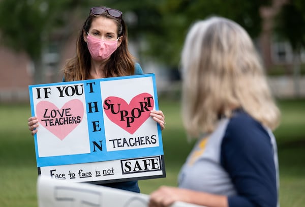 Katie Jonker, a former teacher’s assistant in Decatur who is also the parent of two Decatur High School students, protests the City Schools of Decatur plan to reopen in-person learning by gathering in front of the school’s headquarters in downtown Decatur on Tuesday, Sept. 22, 2020. Ben Gray for the Atlanta Journal-Constitution