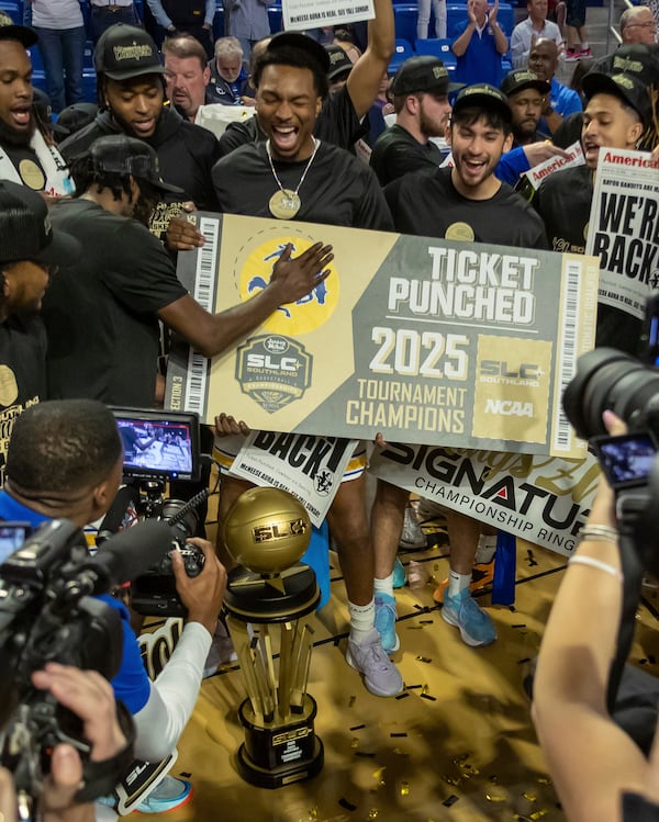 McNeese State celebrate after defeating Lamar in an NCAA college basketball in the championship of the Southland Conference tournament, Wednesday, March 12, 2025, in Lake Charles, La. (Kirk Meche/American Press via AP)