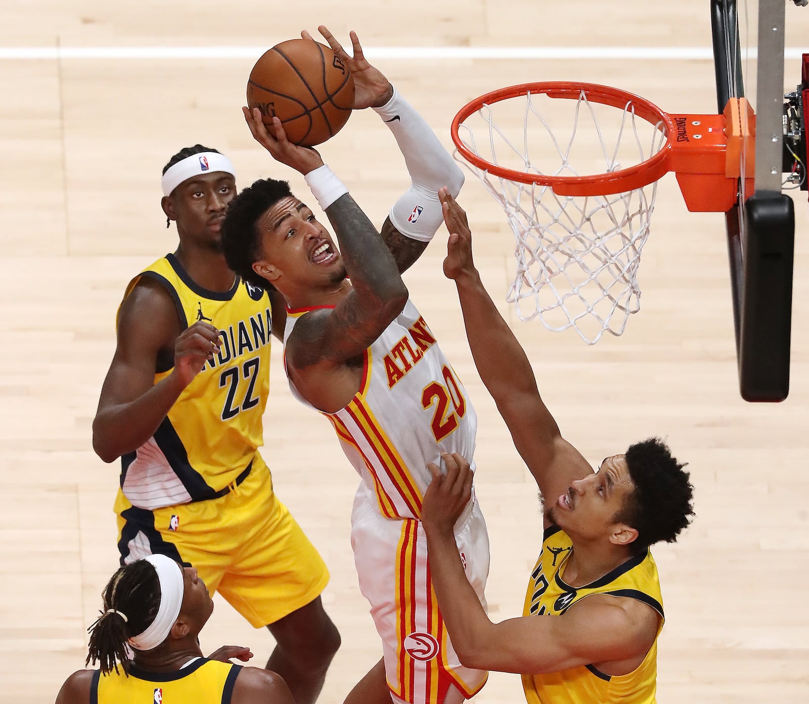 Hawks forward John Collins grabs the offensive rebound and goes to the board against the Indiana Pacers Sunday, April 18, 2021, at State Farm Arena in Atlanta. (Curtis Compton / Curtis.Compton@ajc.com)