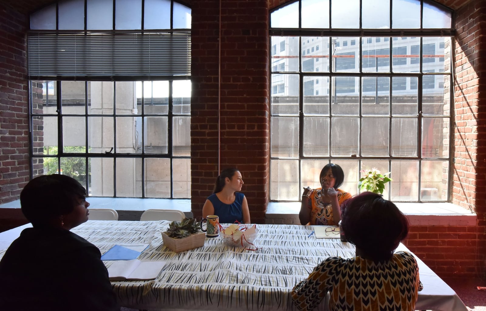 In this AJC file photo from 2017, staff members of the Atlanta/Fulton County Pre-Arrest Diversion Initiative discuss as Atlanta City Detention Center is shown in the background. HYOSUB SHIN / HSHIN@AJC.COM