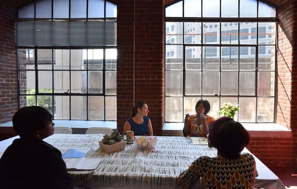 In this AJC file photo from 2017, staff members of the Atlanta/Fulton County Pre-Arrest Diversion Initiative discuss as Atlanta City Detention Center is shown in the background. HYOSUB SHIN / HSHIN@AJC.COM