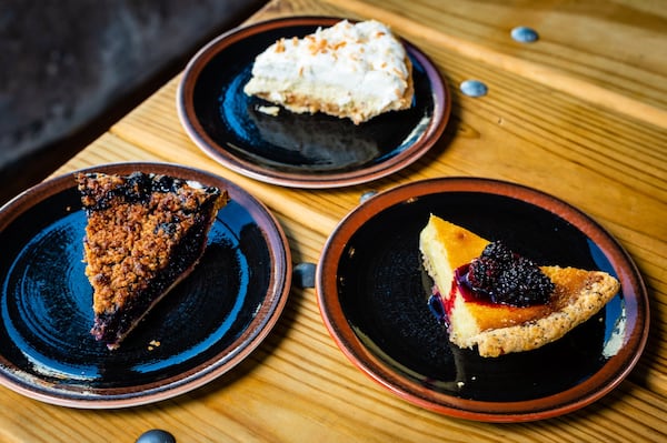 Slices of pie from Woodâ€™s Chapel BBQ, clockwise from left: Black and Blue, Coconut Cream and Lemon-Poppyseed. CONTRIBUTED BY HENRI HOLLIS