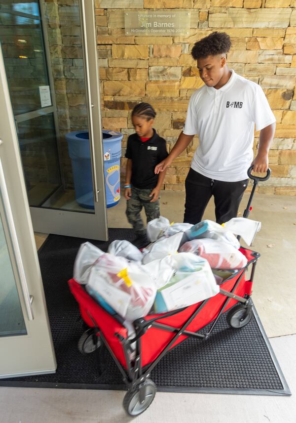 CJ Matthews (right, age 16) & his brother Kollin (7) make a delivery to the Ronald McDonald House as part of their Blankies 4 My Buddies nonprofit. When CJ was 5, his mother tragically lost his baby sister during pregnancy. CJ decided to redirect his grief to give back and spread positivity. He came up with this initiative to offer children comfort and security through blankets. His younger brother, Kollin, is now helping collect and donate the blankets. PHIL SKINNER FOR THE ATLANTA JOURNAL-CONSTITUTION