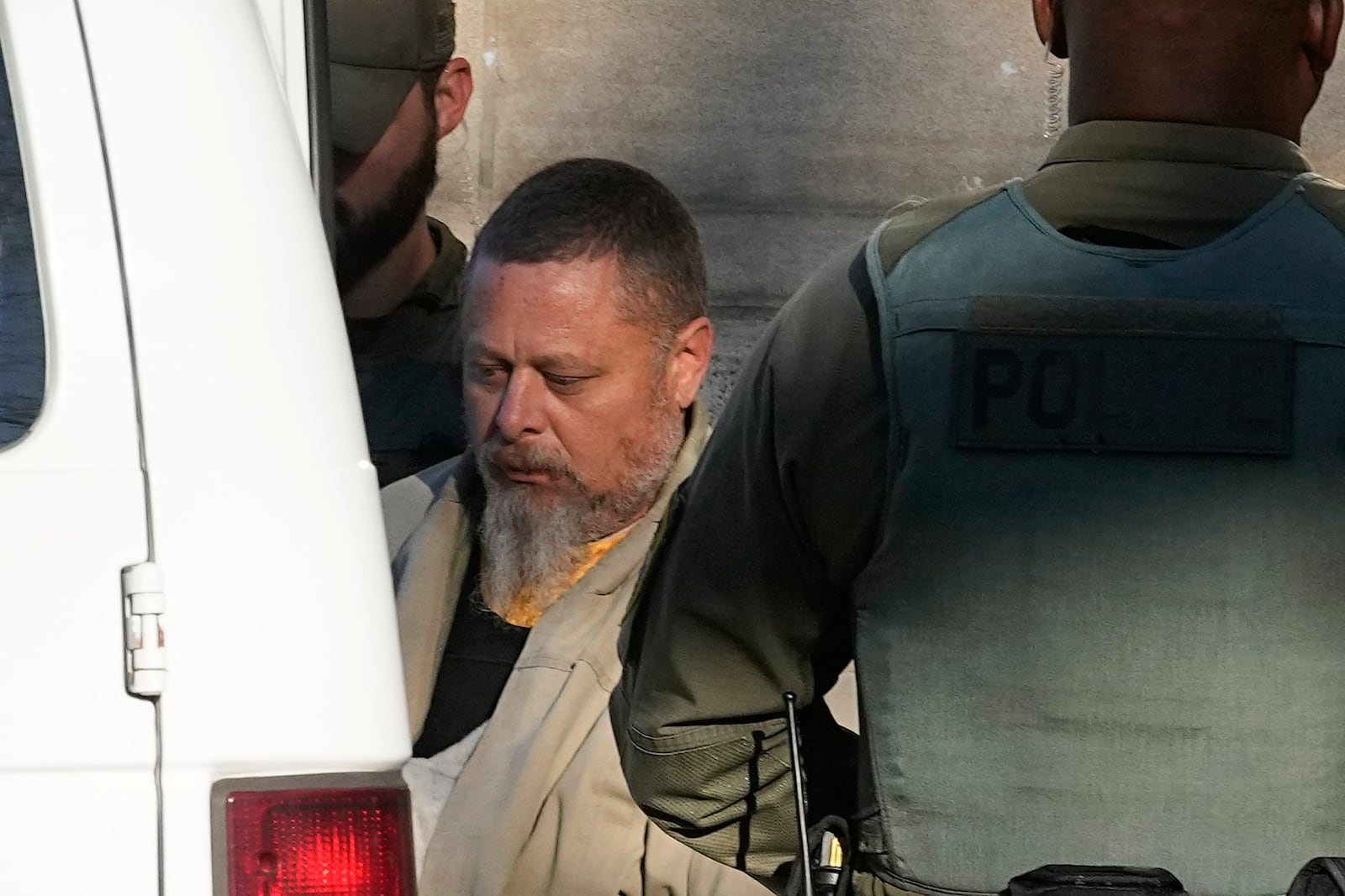 FILE - Officers escort Richard Allen out of the Carroll County courthouse following a hearing, Nov. 22, 2022, in Delphi, Ind. Allen, of Delphi, is scheduled to go on trail Oct. 14, 2024 for the slayings of two teenage girls, Liberty German, 14, and Abigail Williams, 13, who were killed while hiking in 2017 near their small community in northern Indiana hometown. (AP Photo/Darron Cummings, File)