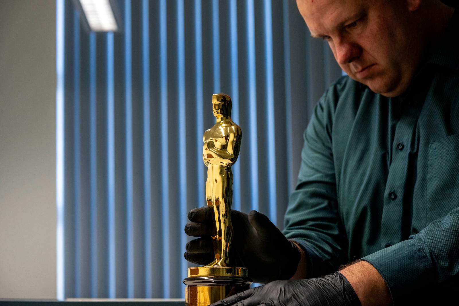 The Best Supporting Actress Oscar won by Shelley Winters for her role in George Stevens' 1959 film, "The Diary of Anne Frank." is displayed by Remco van Doren, manager of the Anne Frank House collection in Amsterdam, Netherlands, Friday, Oct. 4, 2024. (AP Photo/Peter Dejong)