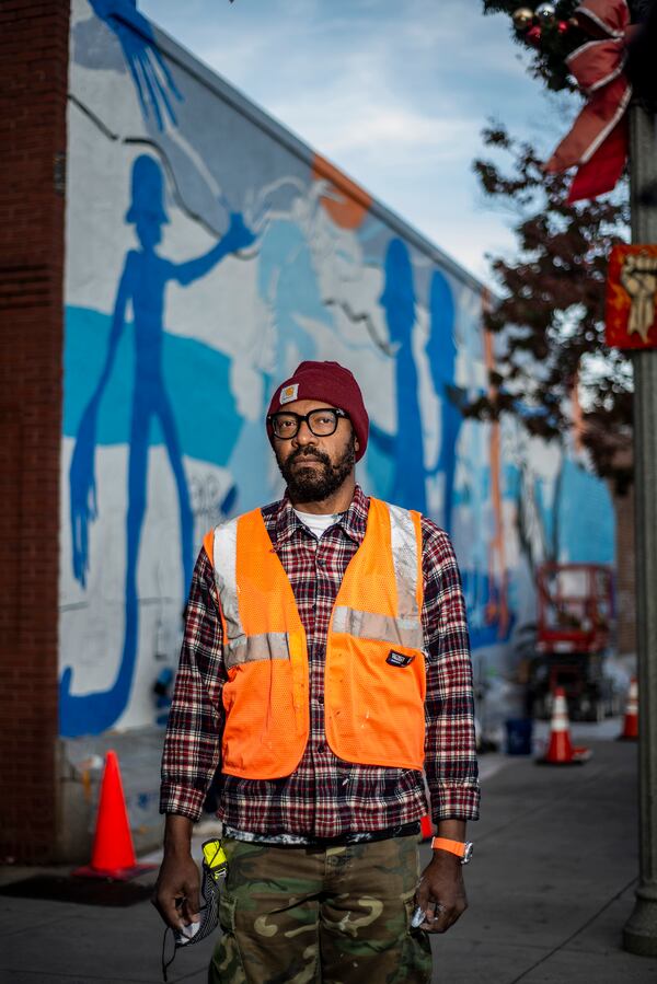 Atlanta artist William Downs with his mural located on Decatur Square.
Courtesy of Sharif Hassan