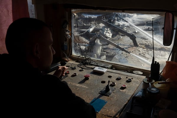 FILE - A worker controls extraction of ilmenite, a key element used to produce titanium, in an open pit mine in the central region of Kirovohrad, Ukraine, Wednesday, Feb. 12, 2025. (AP Photo/Efrem Lukatsky, File)