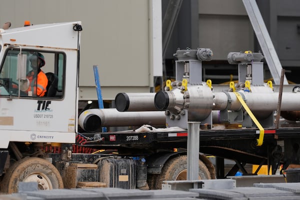 Pipe sections are moved at Entergy's Orange County Advanced Power Station, a 1,215-megawatt facility under construction, Monday, Feb. 24, 2025, in Orange, Texas. (AP Photo/David J. Phillip)