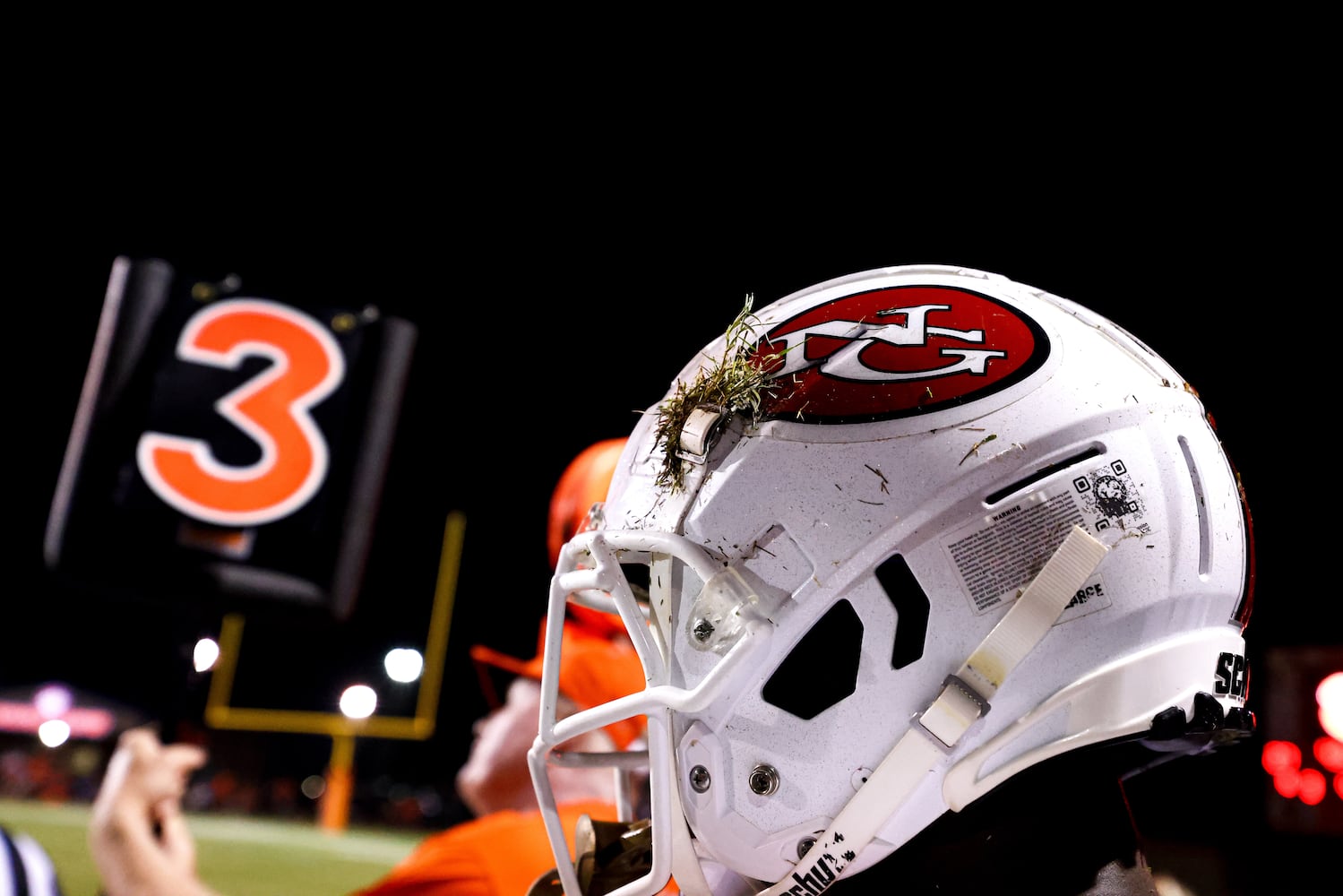 A clump of grass is seen stuck in the helmet of a North Gwinnett player during a GHSA 7A high school football game between the North Gwinnett Bulldogs and the Parkview Panthers at Parkview High School in Lilburn, Ga., on Friday, Sept. 3, 2021. (Casey Sykes for The Atlanta Journal-Constitution)