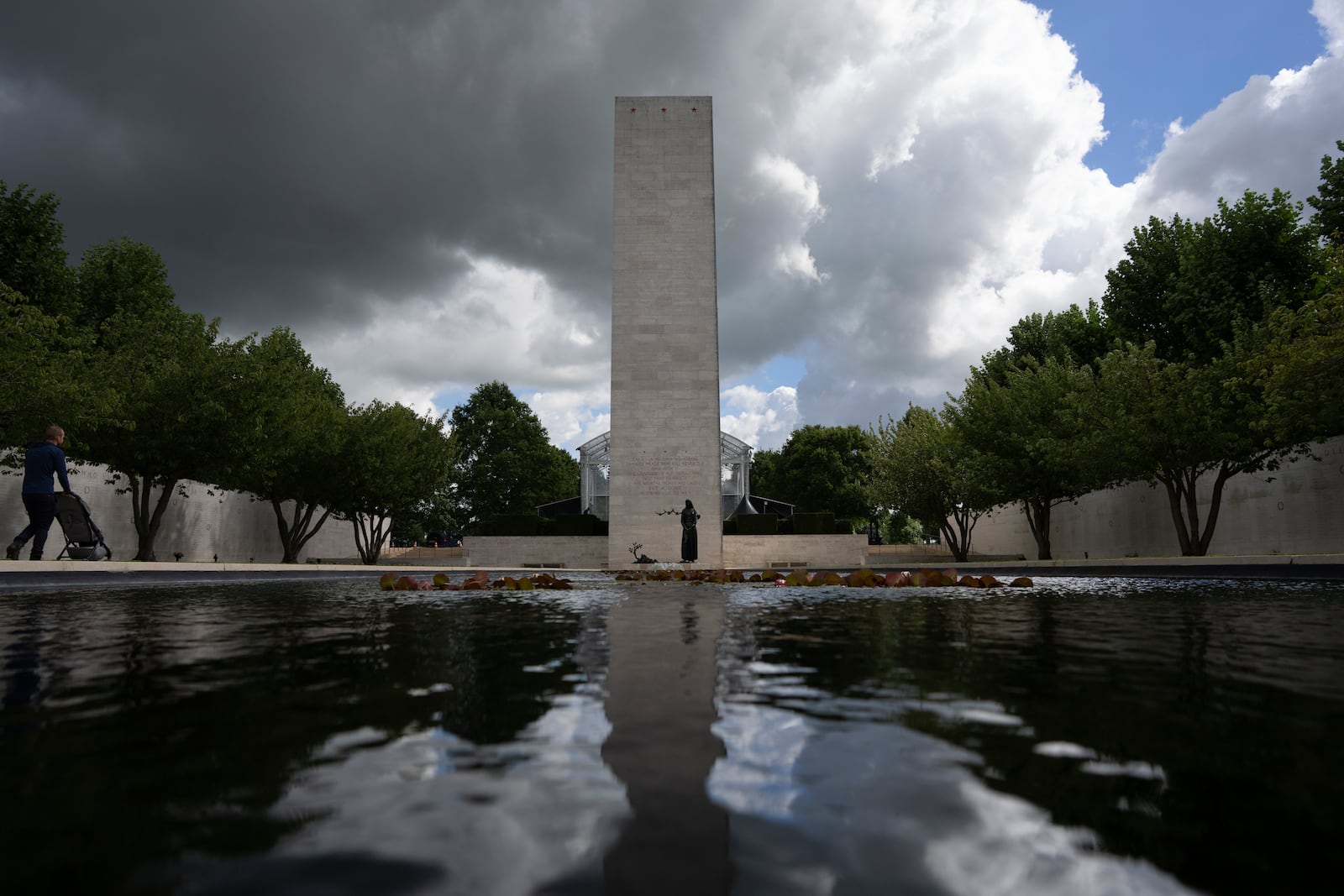 Eighty years after the liberation of the south of the Netherlands a visitor pushes a stroller at the Netherlands American Cemetery in Margraten, southern Netherlands, on Wednesday, Sept. 11, 2024. (AP Photo/Peter Dejong)