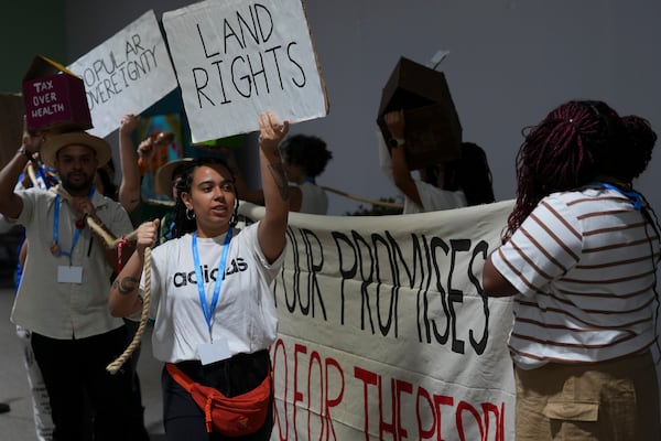 Activists participate in a demonstration for land rights at the COP29 U.N. Climate Summit, Saturday, Nov. 16, 2024, in Baku, Azerbaijan. (AP Photo/Peter Dejong)