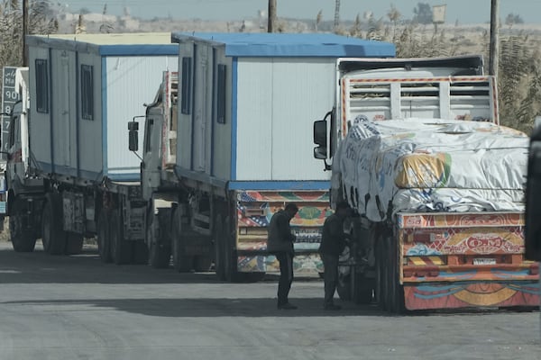 Truck drivers of humanitarian aids wait at Baloza check point, on their way to cross the Rafah border crossing between Egypt and the Gaza Strip , Sunday, Jan. 19, 2025. (AP Photo/Amr Nabil)