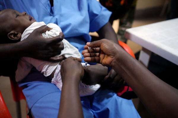 A health worker administers the malaria vaccine R21/Matrix-M to a child at the Health Centre in Yenagoa, Nigeria, Tuesday, Dec. 10, 2024. (AP Photo/Sunday Alamba)