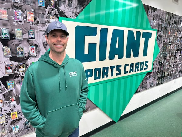 Jon Butts, owner of Giant Sports Cards in Alpharetta, opened his store in 2023, a few months before CardsHQ, opting for a more intimate, family-oriented atmosphere including a wall of cards for sale. RODNEY HO/rho@ajc.com