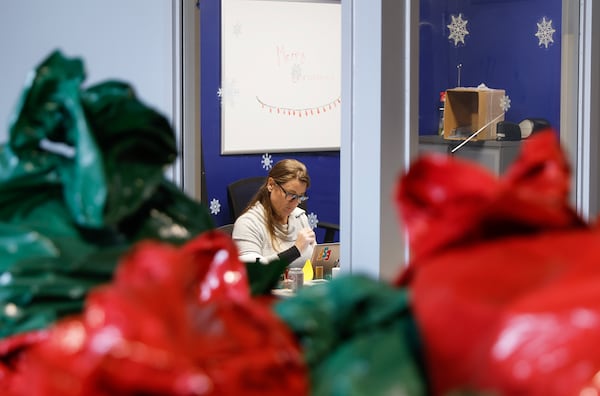 Empty Stocking Fund director Manda Hunt works in her office at the ESF warehouse in Atlanta on Wednesday, December 21, 2022. (Natrice Miller/natrice.miller@ajc.com)  