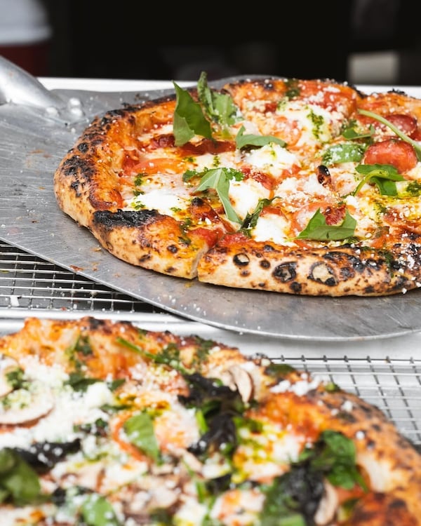 Pies from Atlanta pop-up Ghost Pizza are brushed with sundried tomato butter, sprinkled with cotija cheese and finished with a drizzle of basil oil. / Courtesy of Ghost Pizza