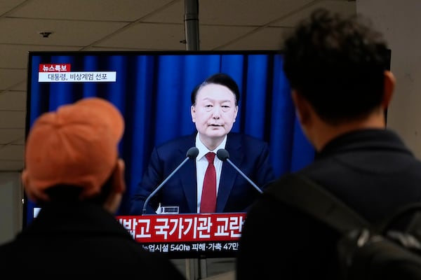 FILE - People watch a TV screen showing South Korean President Yoon Suk Yeol's televised briefing at a bus terminal in Seoul, South Korea, Dec. 3, 2024. (AP Photo/Ahn Young-joon, File)