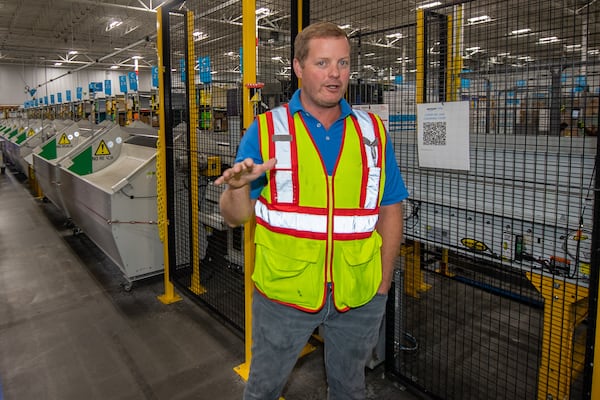 Tyler Deal, site lead at Amazon Duluth delivery station introduces the automatic sorting machine at an Amazon delivery station in Duluth on Tuesday, July 16, 2024.  (Ziyu Julian Zhu / AJC)