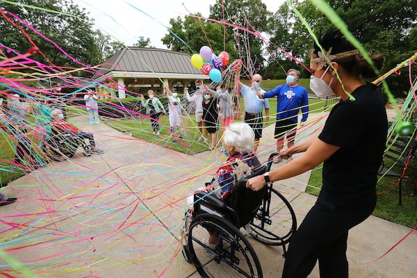 COVID-19 survivor Irma Gooden is showered with confetti by family, friends and staff as director of activities Brock Staples wheels her outside to celebrate her 100th birthday at Westbury Medical Care & Rehab on Tuesday, June 16, 2020, in Jackson. Gooden is one of more than 80 residents at Westbury Medical Care and Rehab who tested positive for COVID-19 and recovered. CURTIS COMPTON / CCOMPTON@AJC.COM