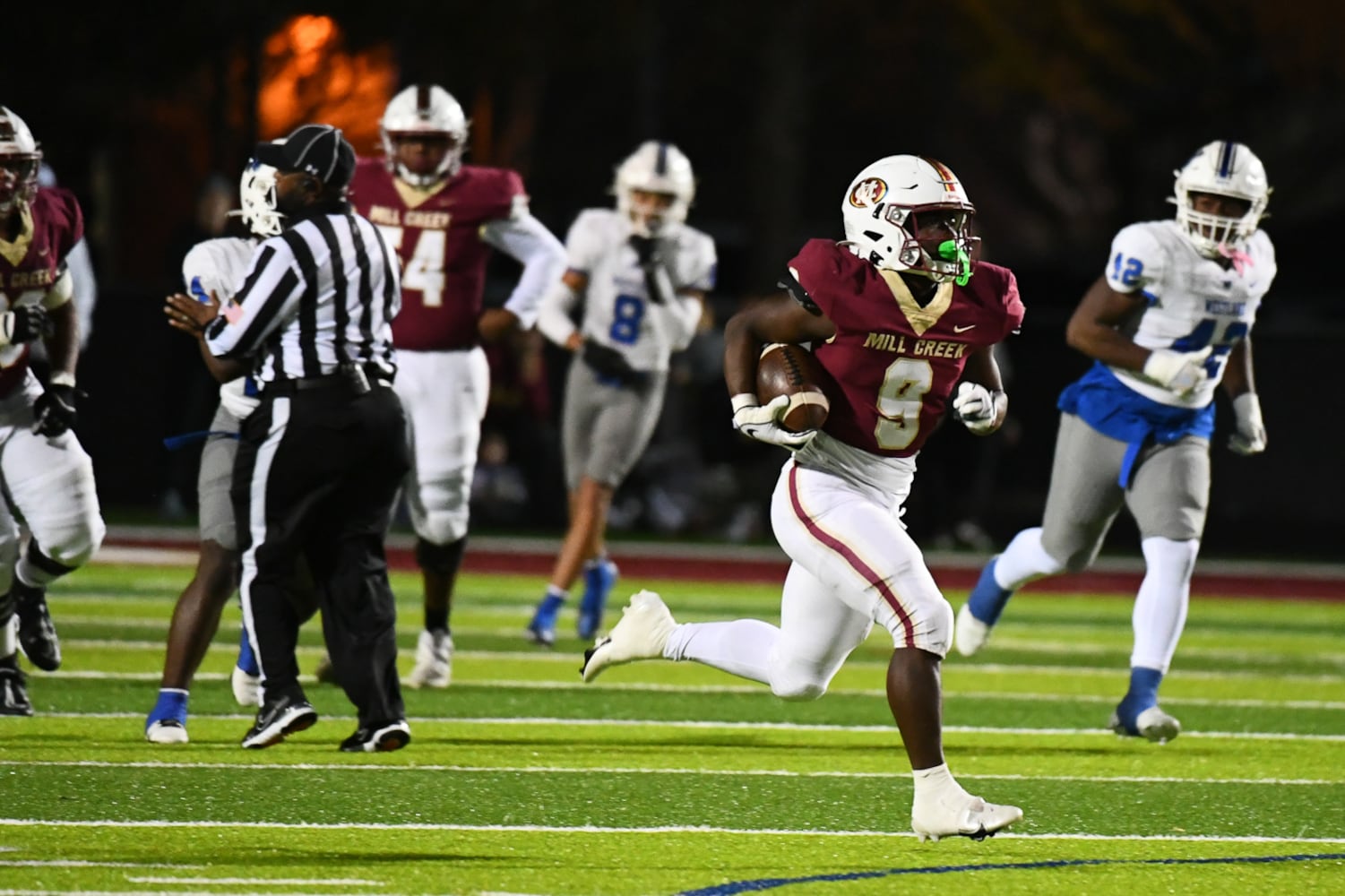 Cameron Robinson runs the ball for Mill Creek. (Jamie Spaar for the Atlanta Journal Constitution)