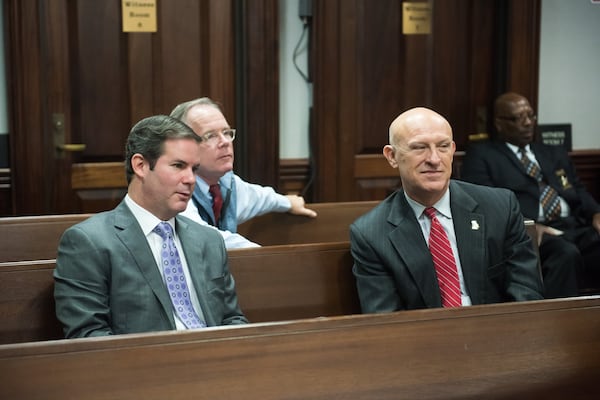 Lead prosecutor Chuck Boring, left, and Cobb County District Attorney Vic Reynolds sit in the gallery as evidence is prepared to send to the jurors for their deliberations last week. (John Carrington / for the AJC)