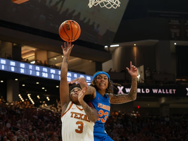 Texas guard Rori Harmon (3) is fouled by Florida guard Liv McGill (23) during the second half an NCAA college basketball game, Sunday, March 2, 2025, in Austin, Texas. (AP Photo/Michael Thomas)