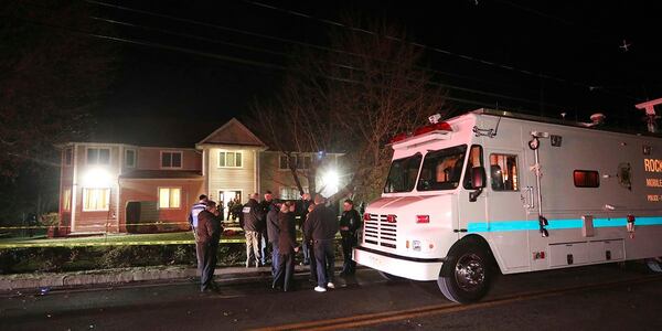 Police work the scene of a residence early Sunday in Monsey, N.Y., after stabbings late Saturday during a Hanukkah celebration.