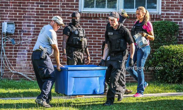 The South Fulton police narcotics unit carries out equipment and suspected drugs from a home on Ocean Valley Road on Friday morning. 