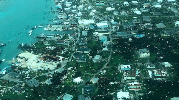 This aerial photo provided by Medic Corps, shows the destruction brought by Hurricane Dorian on Man-o-War cay, Bahamas, . Multiple cruise line companies have pledged to help the region recover from the storm.