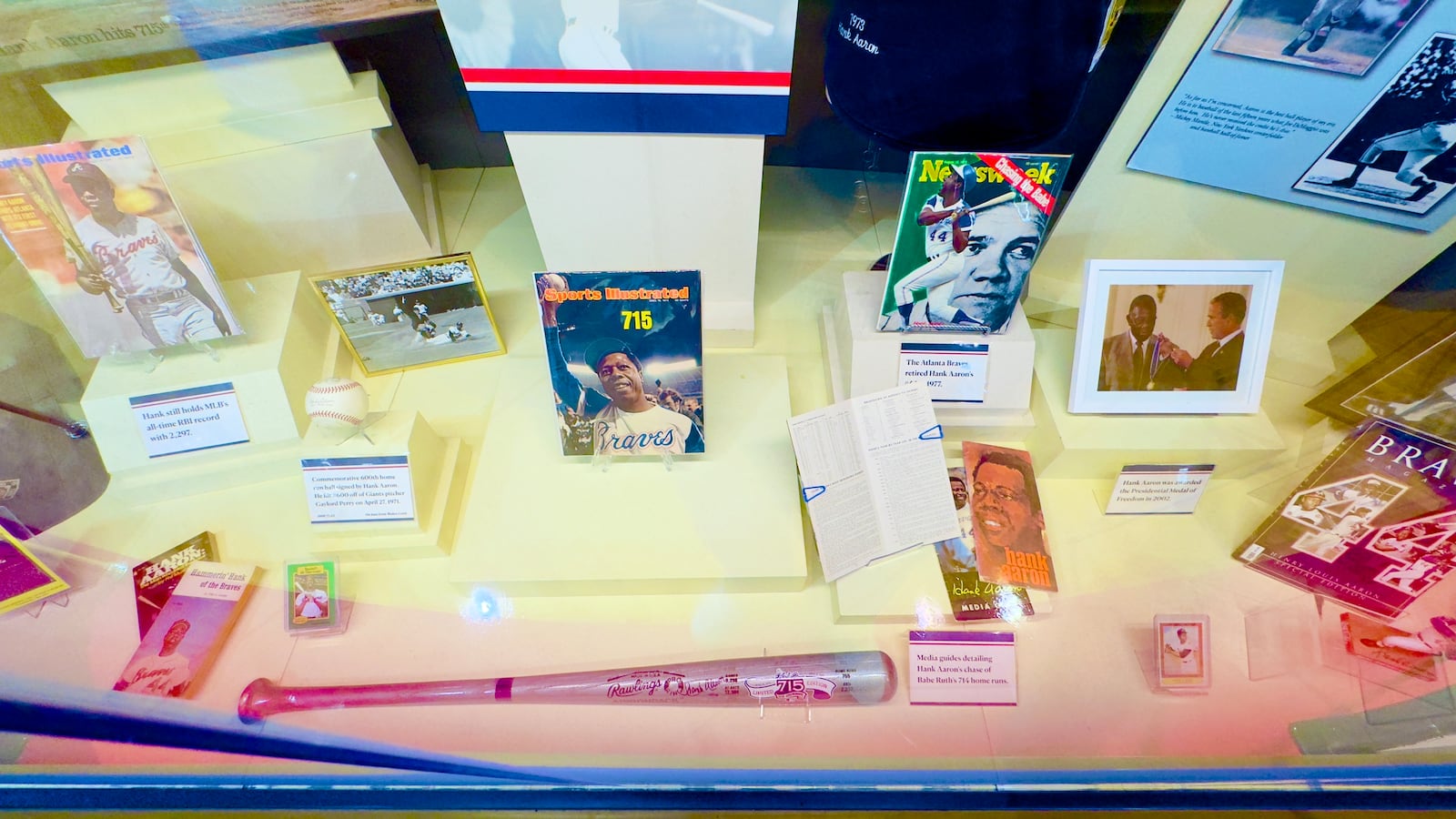 Some of the items on display through July at the Georgia Sports Hall of Fame in an exhibit saluting the 50th anniversary of Hank Aaron's record-breaking home run. (Joe Kovac Jr. / AJC)