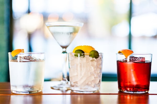 Cocktails at Forza Storico include (from left) the Negroni Bianco; the Forza Martini, which comes with olives and lemon peel neatly cut; and a classic Negroni. CONTRIBUTED BY HENRI HOLLIS