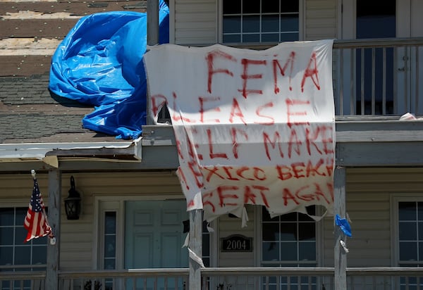 The plea on a tattered sign — “FEMA Please help make Mexico Beach great again” — hangs from a damaged home seven months after Hurricane Michael struck Mexico Beach in Florida. 