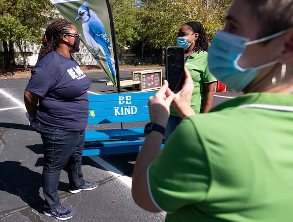 Dione Simon Taylor, principal of Harper-Archer Elementary School in  Atlanta, left, is interviewed by Katrina Reed, school partnerships manager with Out Teach, on Oct. 13, 2020, for a Facebook Live post during an event where volunteers dropped off projects they built for an outdoor learning lab at the school. (Ben Gray for the Atlanta Journal-Constitution)