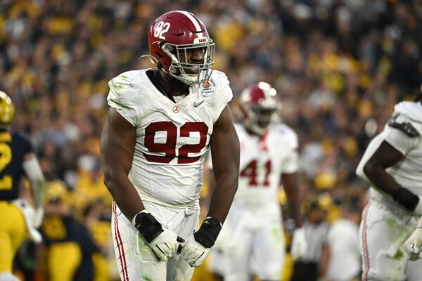 Alabama defensive lineman Justin Eboigbe (92) reacts after tackling Michigan quarterback J.J. McCarthy (9) during the second half of the Rose Bowl CFP NCAA semifinal college football game Monday, Jan. 1, 2024, in Pasadena, Calif. (AP Photo/Kyusung Gong)