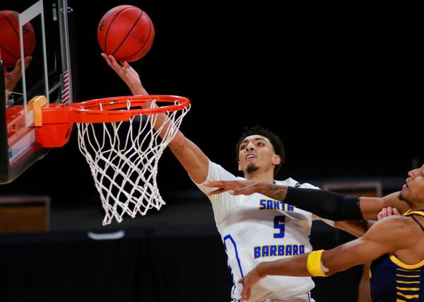 UC Santa Barbara's Miles Norris (5) goes for a shot past UC Irvine's Austin Johnson during the second half of an NCAA college basketball game for the championship of the Big West Conference men's tournament Saturday, March 13, 2021, in Las Vegas. (AP Photo/Ronda Churchill)