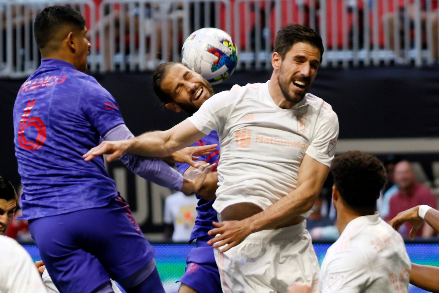 Atlanta United defender Alex de John (center) tries to connect with a header between Columbus Crew defenders in the first half of an MLS soccer match at Mercedes-Benz Stadium on Saturday, May 28, 2022. Miguel Martinez / miguel.martinezjimenez@ajc.com