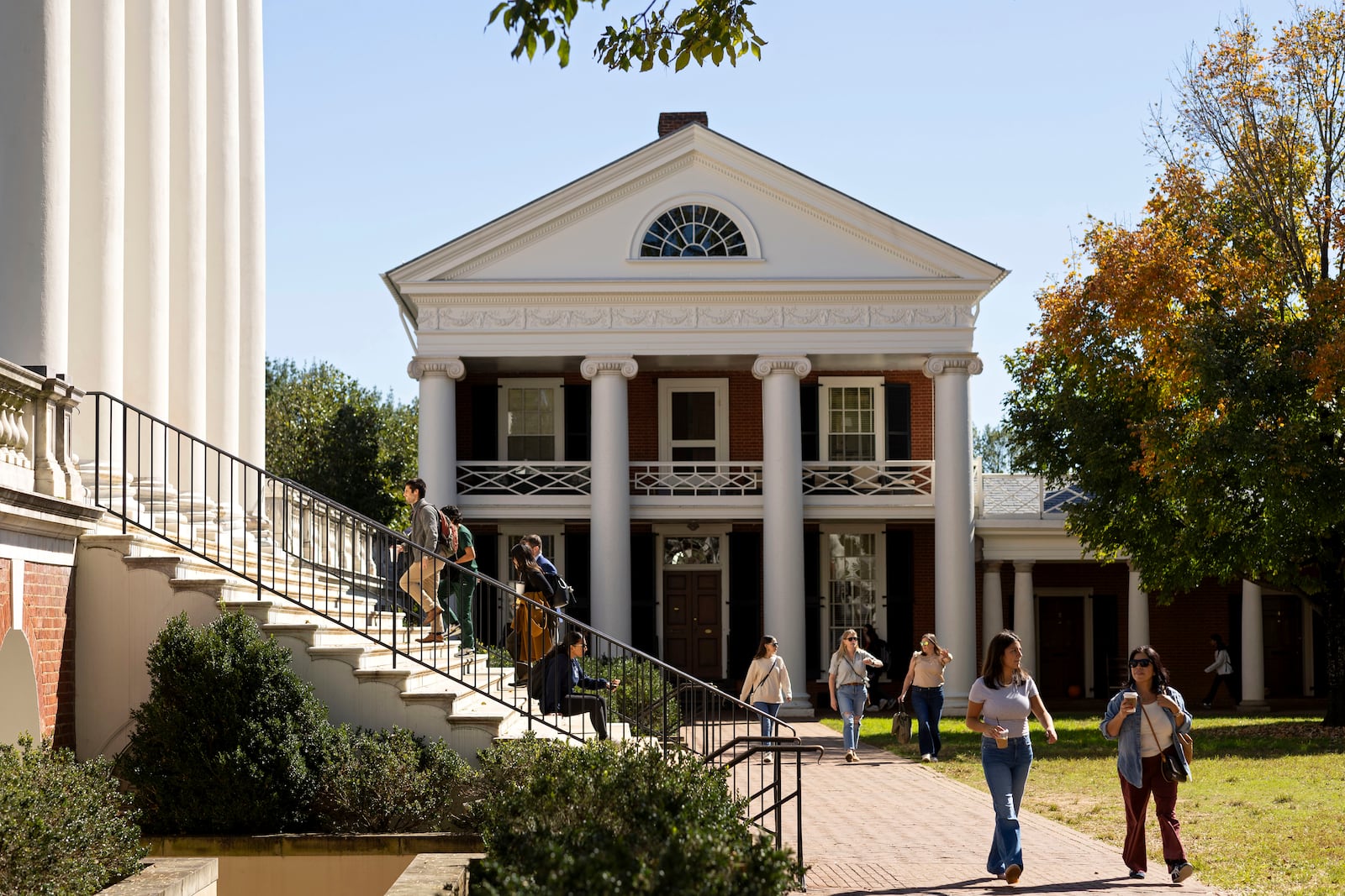 People climb steps to the Rotunda at the University of Virginia in Charlottesville, Va., Friday, Oct. 11, 2024. (AP Photo/Ryan M. Kelly)