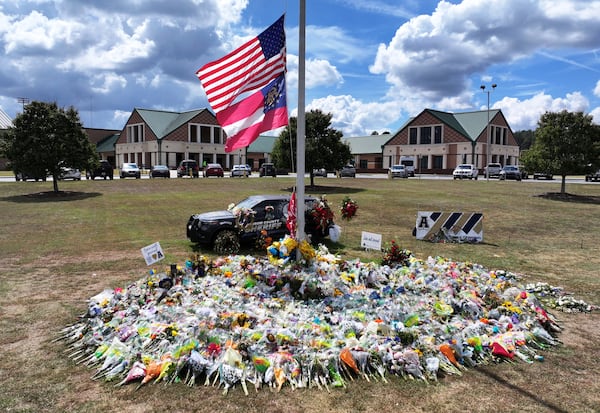 Aerial photo shows a makeshift memorial at Apalachee High School, Thursday, September 19, 2024, in Winder. Students at Apalachee High School outside Atlanta will return to campus for half-days beginning next week, Barrow County school officials announced, after a Sept. 4 shooting that killed four people and injured nine others. (Hyosub Shin / AJC)