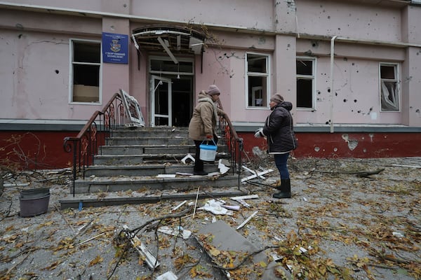 Women clear the rubble from a sports center damaged by a Russian strike in Zaporizhzhia, Ukraine, Nov. 11, 2024. (AP Photo/Kateryna Klochko)