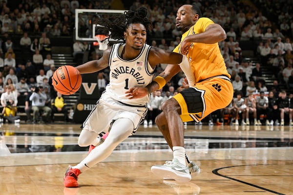 Vanderbilt guard Jason Edwards (1) drives against Missouri guard Tamar Bates (2) during the first half of an NCAA college basketball game Saturday, March 1, 2025, in Nashville, Tenn. (AP Photo/John Amis)