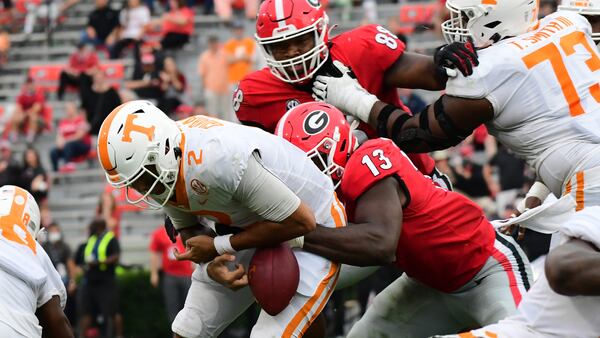 Georgia outside linebacker Azeez Ojulari (13) strips the ball from Tennessee quarterback Jarrett Guarantano (2) Saturday, Oct. 10, 2020, in Athens. (Perry McIntyre/UGA Sports)