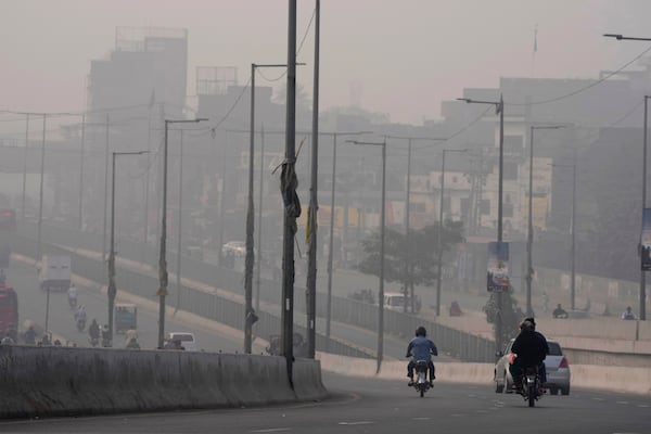 FILE - Traffic moves slow on a road as smog envelops the areas of Lahore, Pakistan, Nov. 2, 2023. (AP Photo/K.M. Chaudary, File)