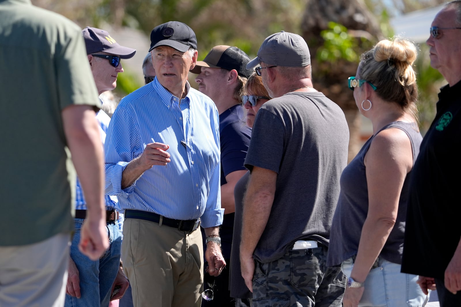 President Joe Biden, second left, meets with residents and federal, state, and local officials in St. Pete Beach, Fla., during a tour of areas affected by Hurricane Milton, Sunday, Oct. 13, 2024. (AP Photo/Manuel Balce Ceneta)