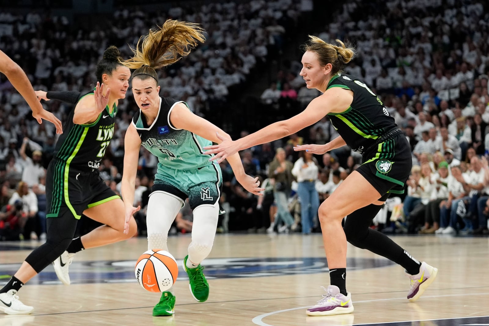 New York Liberty guard Sabrina Ionescu (20) drives to the basket abasing Minnesota Lynx forward Cecilia Zandalasini (9) during the first half of Game 4 of a WNBA basketball final playoff series, Friday, Oct. 18, 2024, in Minneapolis. (AP Photo/Abbie Parr)