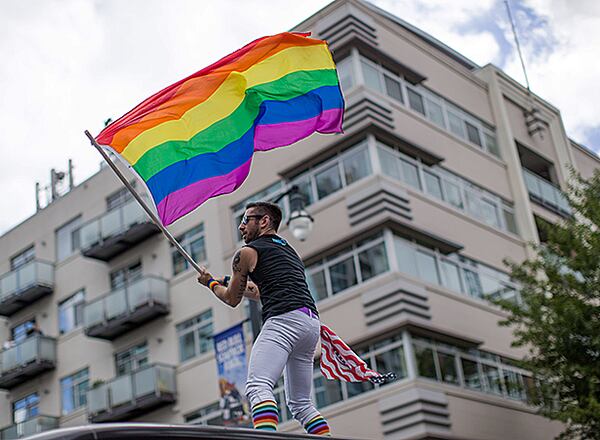 A man waves a rainbow flag during the Atlanta Pride Parade in this 2015 file photo (BRANDEN CAMP/SPECIAL)