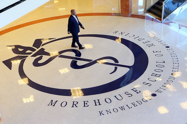 Dr. Louis W. Sullivan, the founding dean and first president of Morehouse School of Medicine, walks across the school logo in the lobby of the building bearing his name, the Louis W. Sullivan National Center for Primary Care, in this 2014 file photo. CURTIS COMPTON / CCOMPTON@AJC.COM